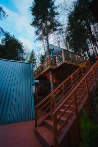 a large wooden deck with a wooden railing on a house at Montana Suite Bungalows in Akcaabat