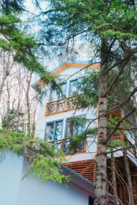 a house with a balcony on the side of it at Montana Suite Bungalows in Akcaabat