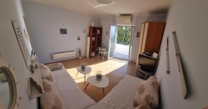 ein Wohnzimmer mit einem Sofa und einem Tisch in der Unterkunft Apartment with direct Sea View, Free Parking and close to Beaches and Promenade in Lovran