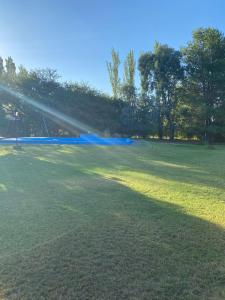 a large field with a sprinkler in a park at Quinta Los Patos in Toay