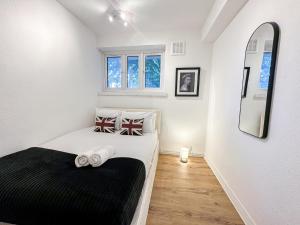 a bedroom with a bed with a black blanket at Vibrant 3BR flat near Finsbury Park in London