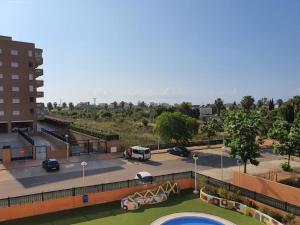 a parking lot with a pool and a building at Torre la Sal - Encanto natural 2 in Cabanes