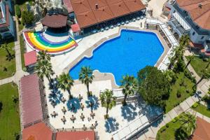 an overhead view of a large swimming pool with a rainbow at Lykia Botanika Beach Fun & Club - All Inclusive in Fethiye