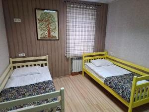 a bedroom with two beds and a window at Guest house "Golden Gate" in Kyiv