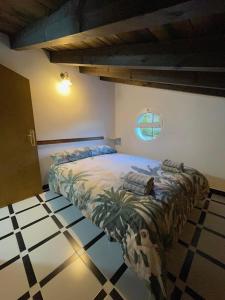 um quarto com uma cama num quarto com piso em azulejo em CASA UMBRIA em Yunquera