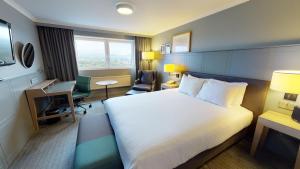 a hotel room with a bed and a desk at Holiday Inn Edinburgh Zoo, an IHG Hotel in Edinburgh