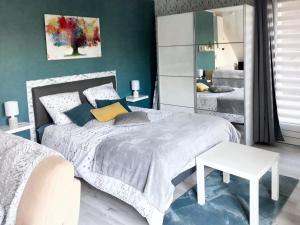 a bedroom with a white bed and a mirror at Studio avec piscine partagee jardin clos et wifi a Saint Apollinaire in Saint-Apollinaire
