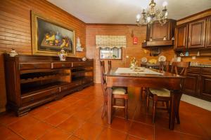 a kitchen with a table and a dining room at Quinta de São Francisco in Cinfães +14 photos