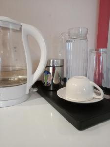 a white blender and a white plate on a counter at Edladleni Guesthouse Quigney in East London