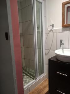 a bathroom with a shower and a sink at Edladleni Guesthouse Quigney in East London