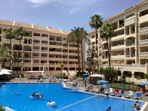 a swimming pool in front of a large hotel at Estupendo Estudio en Castle Harbour Los Cristianos in Los Cristianos