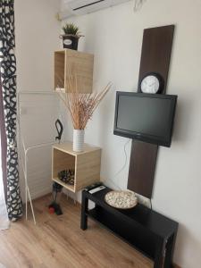 a living room with a tv and a table at Studio Marina Cape 89 in Aheloy