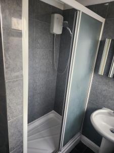 a bathroom with a shower and a sink at Sariyu space in Dagenham