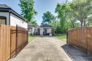 a house with a fence and a driveway at Greenwood Studio Cottage Less Than 1 Mi to Downtown! in Greenwood