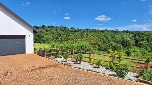 a driveway of a house with a fence at Nature view in Tzaneen