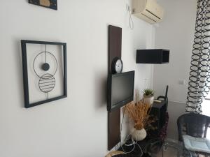 a living room with a tv and a clock on the wall at Relaks w Marina Cape 88 in Aheloy +79 photos