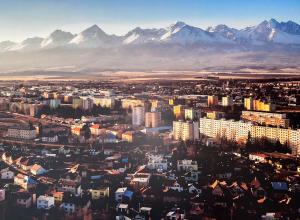 eine Luftansicht einer Stadt mit Bergen im Hintergrund in der Unterkunft Apartment Reduta Celebration in Poprad
