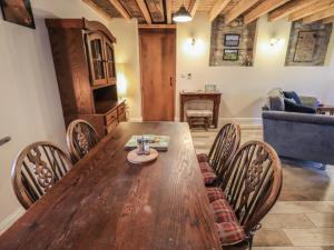 a dining room with a wooden table and chairs at Boskins in Sedbergh