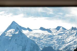 a view of a snow covered mountain range at Mountain Rooms - Night only - Self Check in in Zell am See