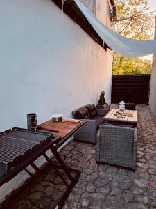an outdoor patio with a table and a couch at Serbian House in Timişoara
