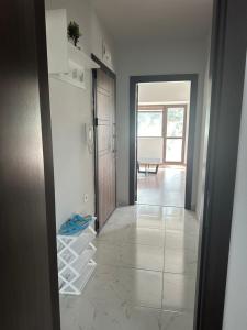 a room with a hallway with white shelves and a door at Varna Vinitsa in Varna City +4 photos