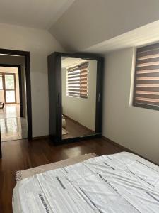 a bedroom with a large mirror and a bed at Varna Vinitsa in Varna City