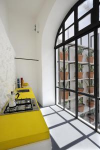 a kitchen with a yellow counter and a window at Capri Kronos GuestHouse in Anacapri