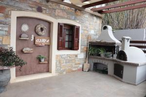 an outdoor patio with a fireplace and a stove at OSTRIA BOUTIQUE HOME in Kalymnos