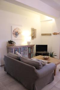 a living room with a couch and a table at OSTRIA BOUTIQUE HOME in Kalymnos