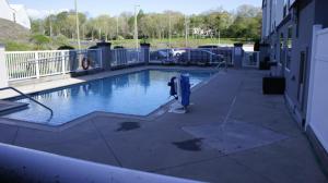 a swimming pool on the side of a building at Hawthorn Extended Stay by Wyndham Knoxville in Knoxville