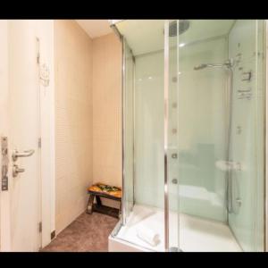 a bathroom with a shower with a glass door at Happy at Chiado in Lisbon
