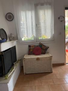 a room with a window and a bench in a room at Lefki's House in AgiaKampos
