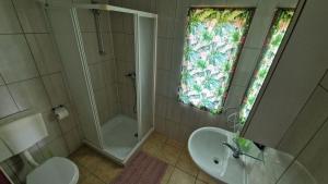 a bathroom with a shower and a sink and a toilet at Zielona Przestrzeń in Polańczyk +27 photos