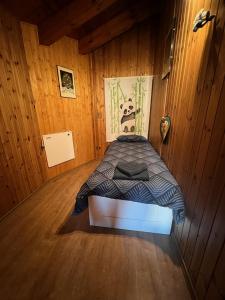 1 dormitorio con 1 cama en una habitación de madera en casa del sole, en Saint-Pierre