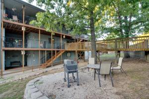 a house with a deck and a table and chairs at Family-Friendly Condo 1 Mi to Silver Dollar City! in Branson West