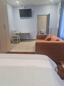 a living room with a couch and a table at Homestay Goodwood in Cape Town +12 photos