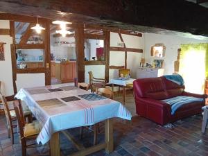 a living room with a table and a couch at La Treille in Treigny