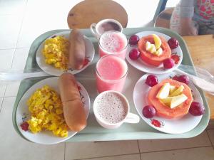 a tray of food with hot dogs and fruit and drinks at CABAÑA ALTO DE LUNA 1 in La Vega