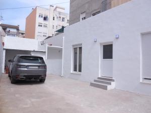 a truck parked in a parking lot next to a white building at Benicasim Village by Tucasanlaplaya in Benicàssim