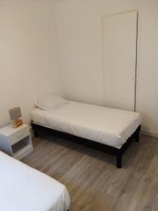 a room with two beds and a cabinet at Bienvenus ! Appartement jaune in Marseille