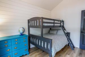 a bedroom with a bunk bed and a blue dresser at Drifting Snow Cabin - Pinetop, AZ in Indian Pine