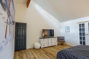 a bedroom with a bed and a tv and a dresser at Drifting Snow Cabin - Pinetop, AZ in Indian Pine
