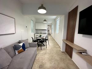 a living room with a gray couch and a table at Urban-Styled Apartment in Santurce in San Juan