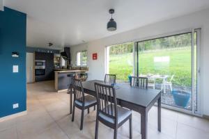 a kitchen and dining room with a table and chairs at La 745 Summer Holiday home near the sea in Commes