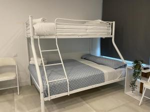a bedroom with a bunk bed with a ladder at C10 Exclusiva zona Madrid cerca Bernabéu in Madrid