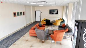 a living room with couches and chairs and a table at Vizyon Otel Darıca in Darıca