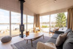 a living room with a couch and a fireplace at Stay North - Villa Katajala in Hämeenlinna