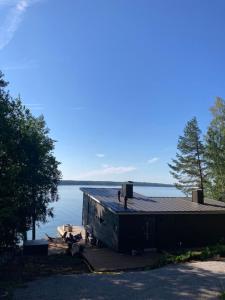 a house on a dock on a lake at Stay North - Villa Kalksved in Sipoo