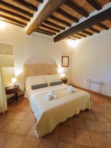 a bedroom with a large bed with towels on it at Gest Short Rent Siena 5 in Siena