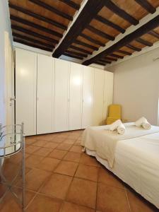 a bedroom with two beds and white cabinets at Gest Short Rent Siena 5 in Siena